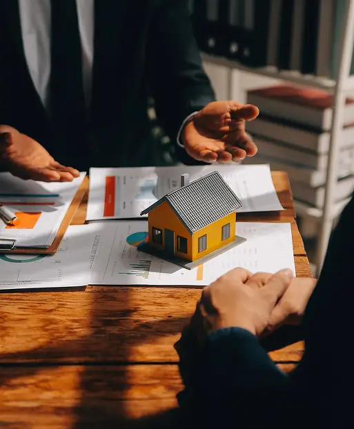 Estate planning professional discussing property and estate planning documents with a client