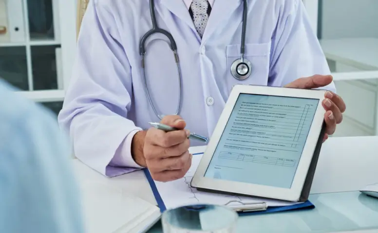 Doctor explaining healthcare documents to a patient during a medical consultation